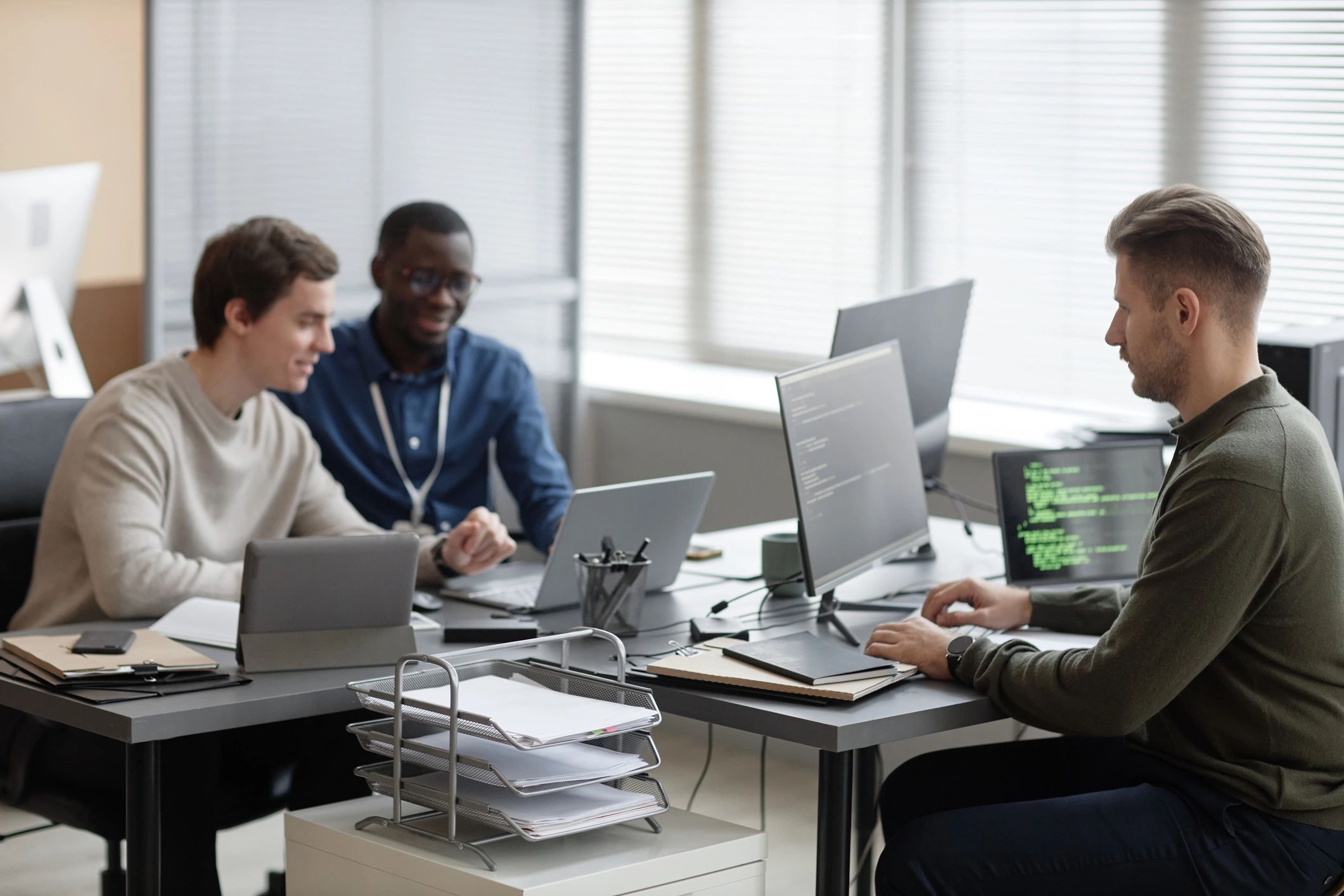 Professional team collaborating in a modern technology office